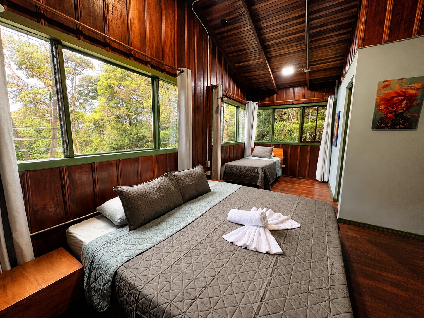 Standard Colibrí Room with timber-clad walls and forest views